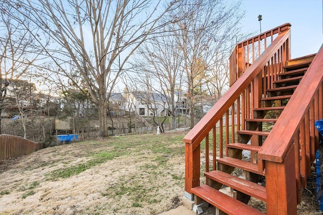 view of yard with stairs and fence