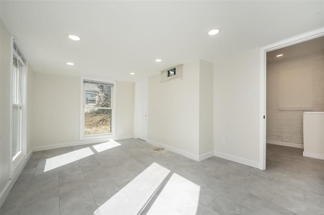 empty room with recessed lighting and baseboards