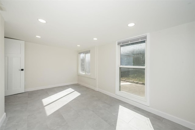 empty room with recessed lighting and baseboards