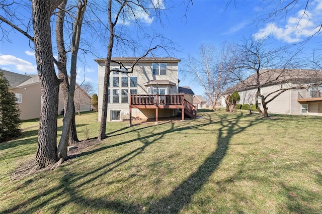 back of property featuring a lawn and a wooden deck