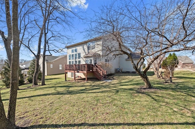 rear view of house with a deck, a yard, and stairway