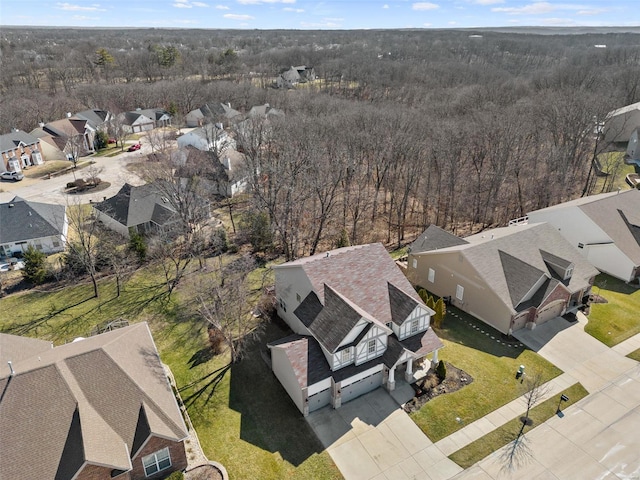 bird's eye view featuring a residential view and a wooded view