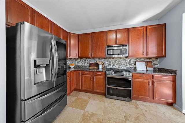 kitchen with dark stone counters, appliances with stainless steel finishes, brown cabinetry, and tasteful backsplash