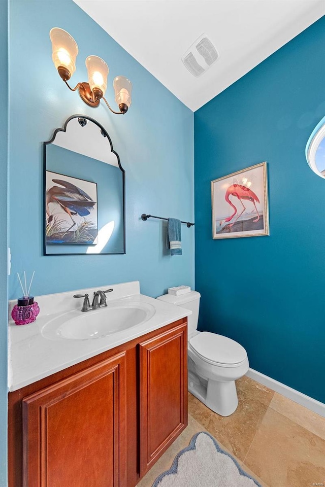 bathroom with baseboards, visible vents, vanity, and toilet