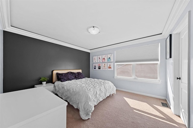 carpeted bedroom with baseboards, visible vents, and crown molding