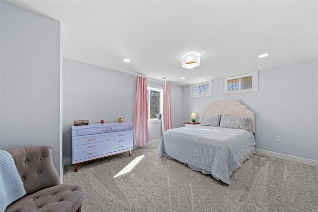 carpeted bedroom featuring baseboards and recessed lighting