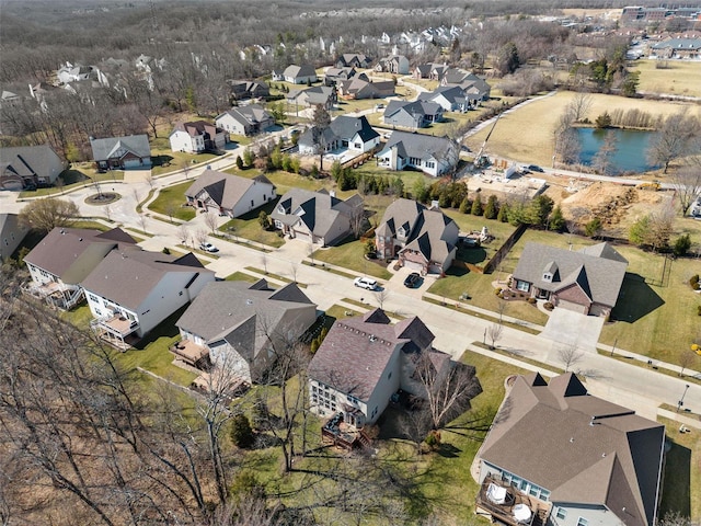 bird's eye view featuring a water view and a residential view