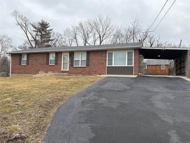 ranch-style home with a carport and a front yard