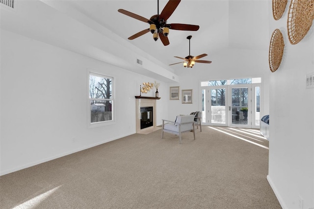 unfurnished room featuring carpet and high vaulted ceiling