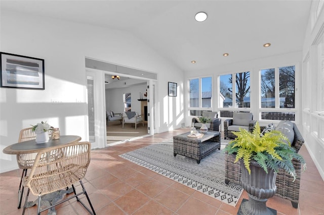 living room with lofted ceiling and tile patterned floors