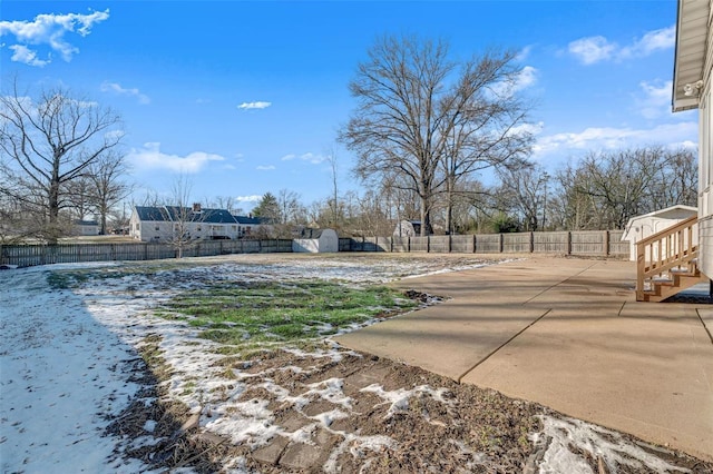 view of yard featuring a patio area and a storage unit