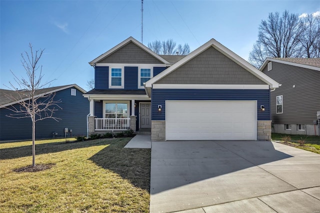 craftsman-style home with a garage, concrete driveway, stone siding, a porch, and a front yard