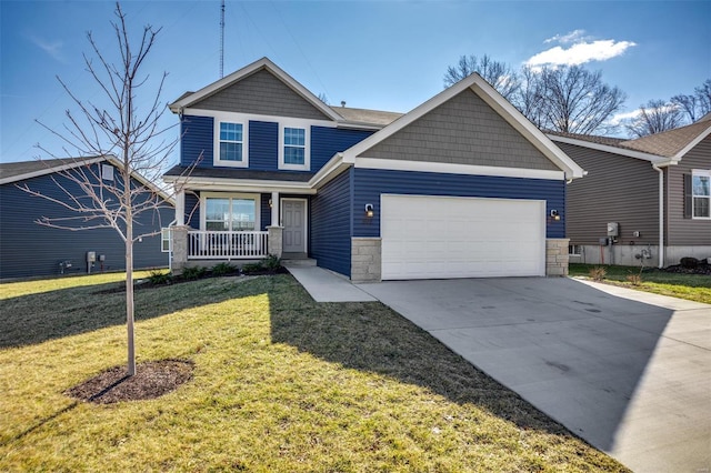 craftsman inspired home featuring a porch, an attached garage, concrete driveway, stone siding, and a front yard