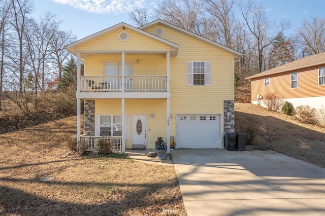 view of front of house with a garage, a balcony, and a porch