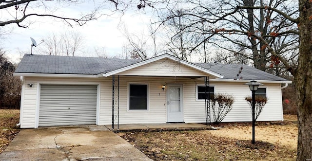 ranch-style house featuring concrete driveway and an attached garage