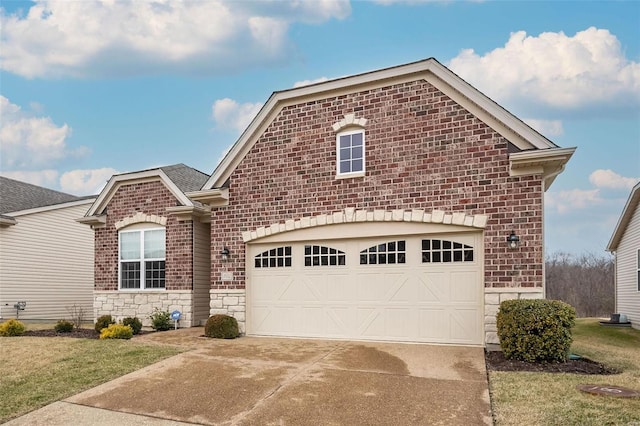 view of front of house with driveway, stone siding, a garage, and brick siding