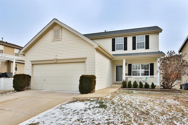 traditional-style home with covered porch, concrete driveway, and a garage