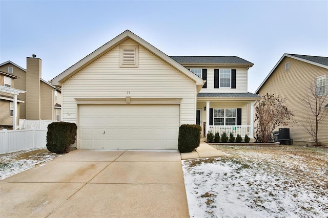 traditional-style home with a porch, concrete driveway, fence, and an attached garage