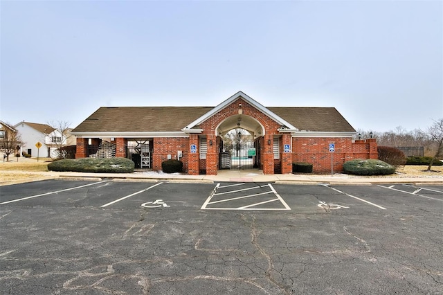 view of property featuring uncovered parking and fence