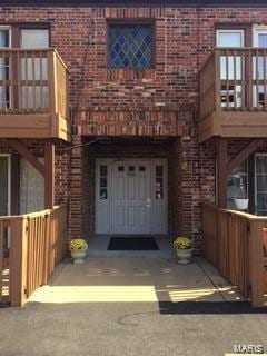 doorway to property with brick siding