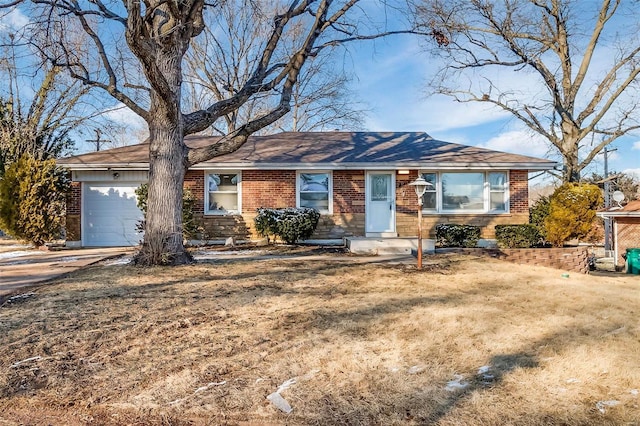 ranch-style home with a garage and a front yard