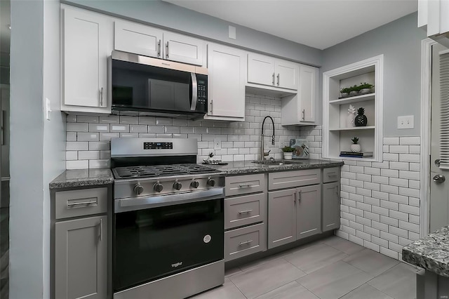 kitchen featuring white cabinetry, sink, gray cabinets, and appliances with stainless steel finishes