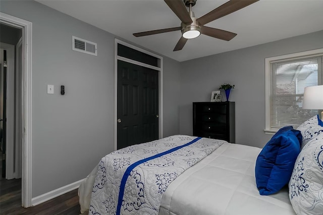 bedroom featuring ceiling fan, wood-type flooring, and a closet