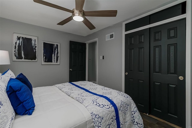 bedroom featuring dark hardwood / wood-style floors, a closet, and ceiling fan