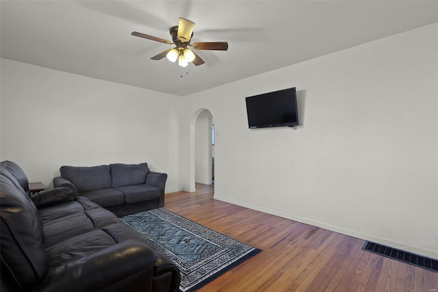 living room with ceiling fan and wood-type flooring