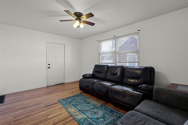 living room featuring ceiling fan and hardwood / wood-style floors