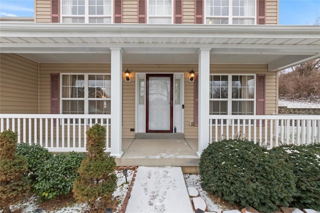 view of exterior entry featuring a porch