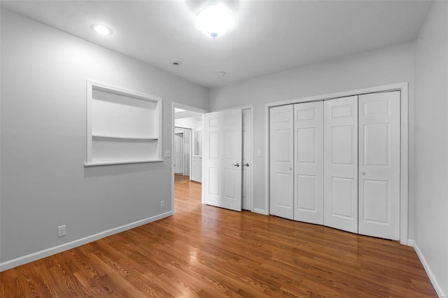 unfurnished bedroom featuring hardwood / wood-style flooring