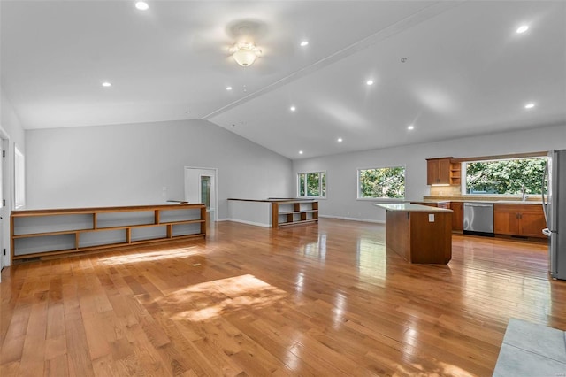 interior space with sink, vaulted ceiling, and light hardwood / wood-style flooring