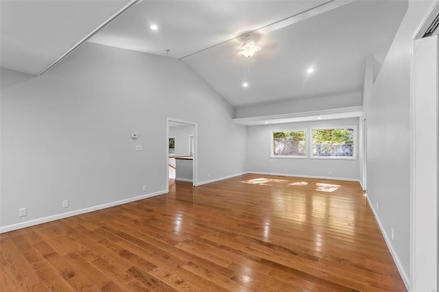 unfurnished living room featuring hardwood / wood-style flooring and high vaulted ceiling