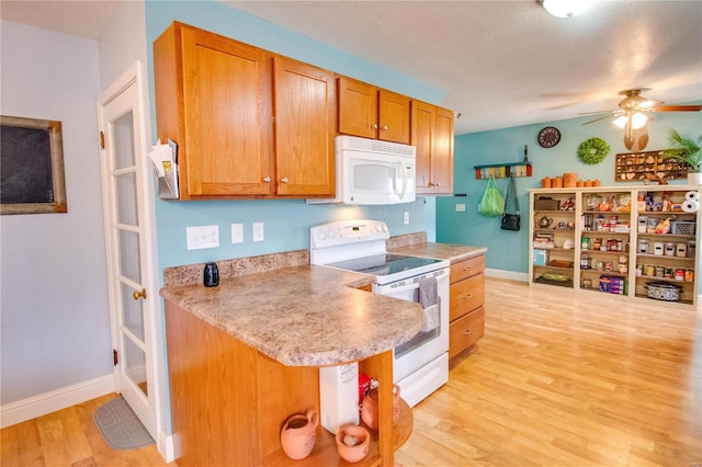 kitchen with ceiling fan, white appliances, and light hardwood / wood-style floors