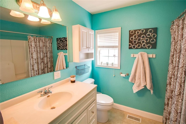 bathroom featuring vanity, a shower with shower curtain, and toilet