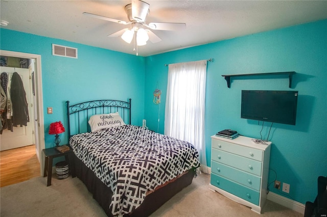 bedroom featuring ceiling fan and light carpet