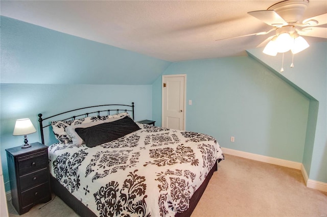 carpeted bedroom featuring lofted ceiling and ceiling fan