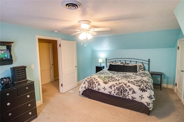 carpeted bedroom featuring ceiling fan, lofted ceiling, and a textured ceiling