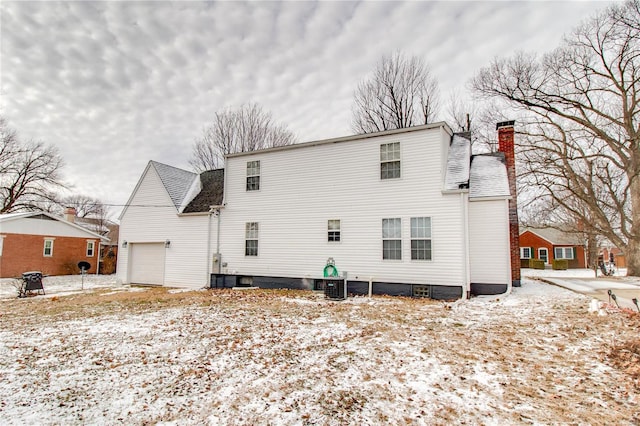 snow covered back of property with cooling unit