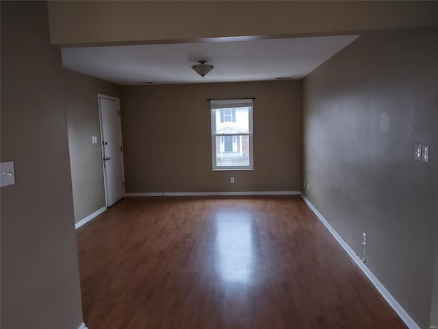 empty room featuring dark wood-type flooring