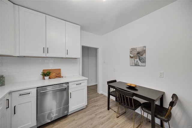 kitchen with white cabinets, dishwasher, light wood-style flooring, light countertops, and backsplash