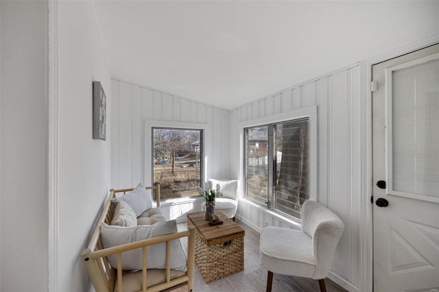 living area with lofted ceiling and wood finished floors