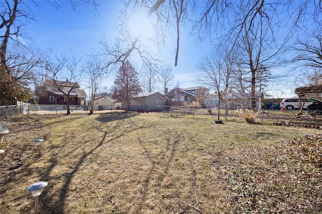 view of yard featuring fence and a residential view