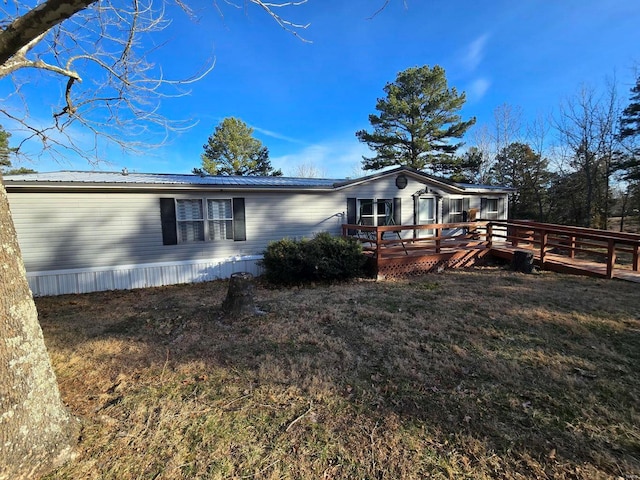 view of front of property with a front yard and a deck