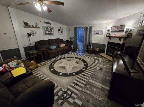 living room featuring lofted ceiling and ceiling fan