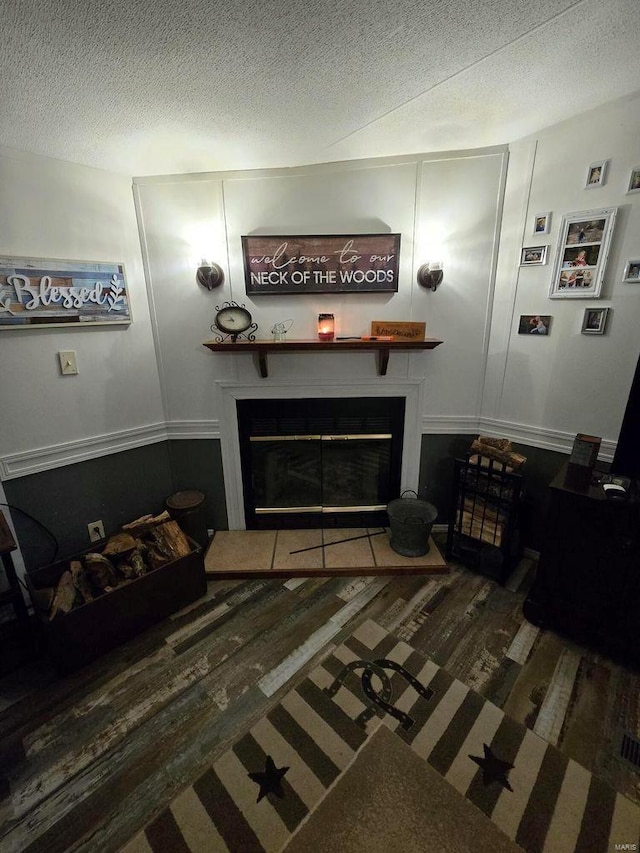 living room featuring dark hardwood / wood-style flooring and a textured ceiling