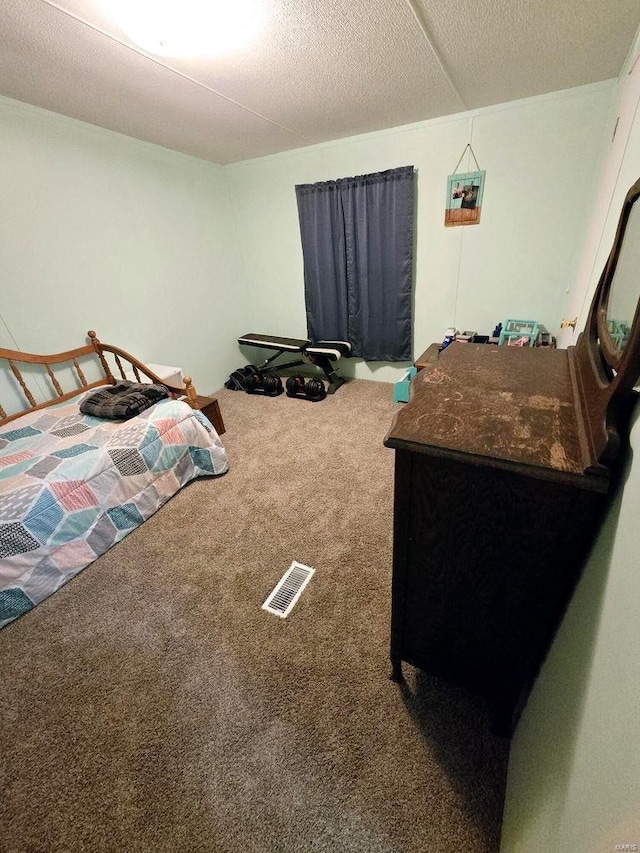 bedroom featuring carpet and a textured ceiling