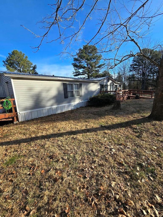 view of property exterior featuring a lawn