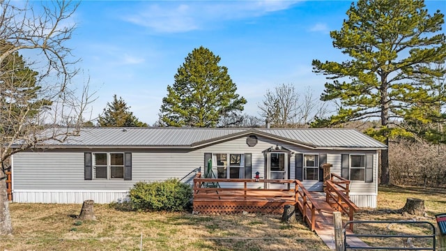 manufactured / mobile home featuring metal roof and a deck